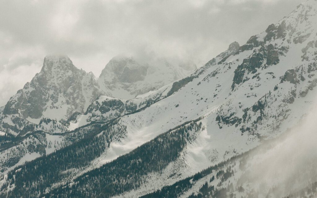 peaks of the teton range in a storm photographed by grand teton national park elopement photographer