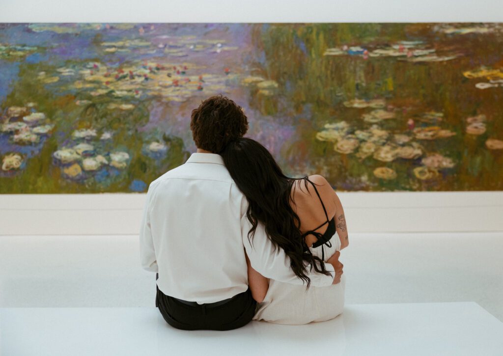 couple looking at a painting taken at carnegie museum of art in pittsburgh taken by pittsburgh engagement photographer