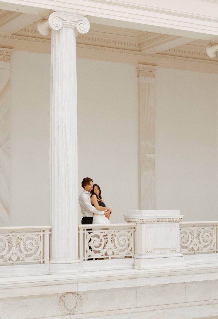 couple holding each other during engagement session taken at art museum in pittsburgh taken by pittsburgh wedding photographer