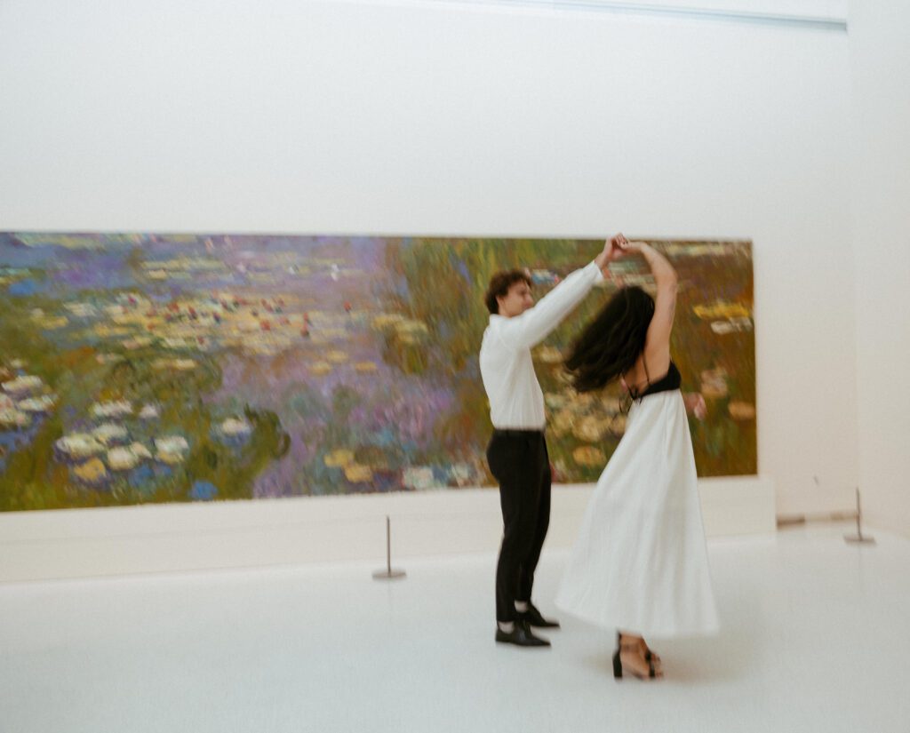 couple dancing in front of a painting at carnegie museum of art taken by Rock & Wander Photo Co