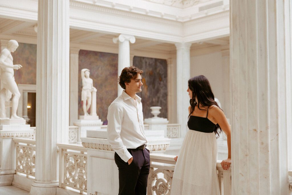 couple looking at each other at carnegie museum of art photographed by pittsburgh engagement photographer