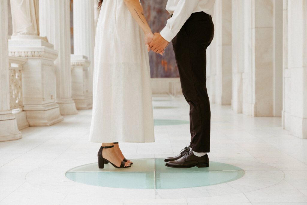 couple holding hands in the hall of sculpture taken by pittsburgh wedding photographer