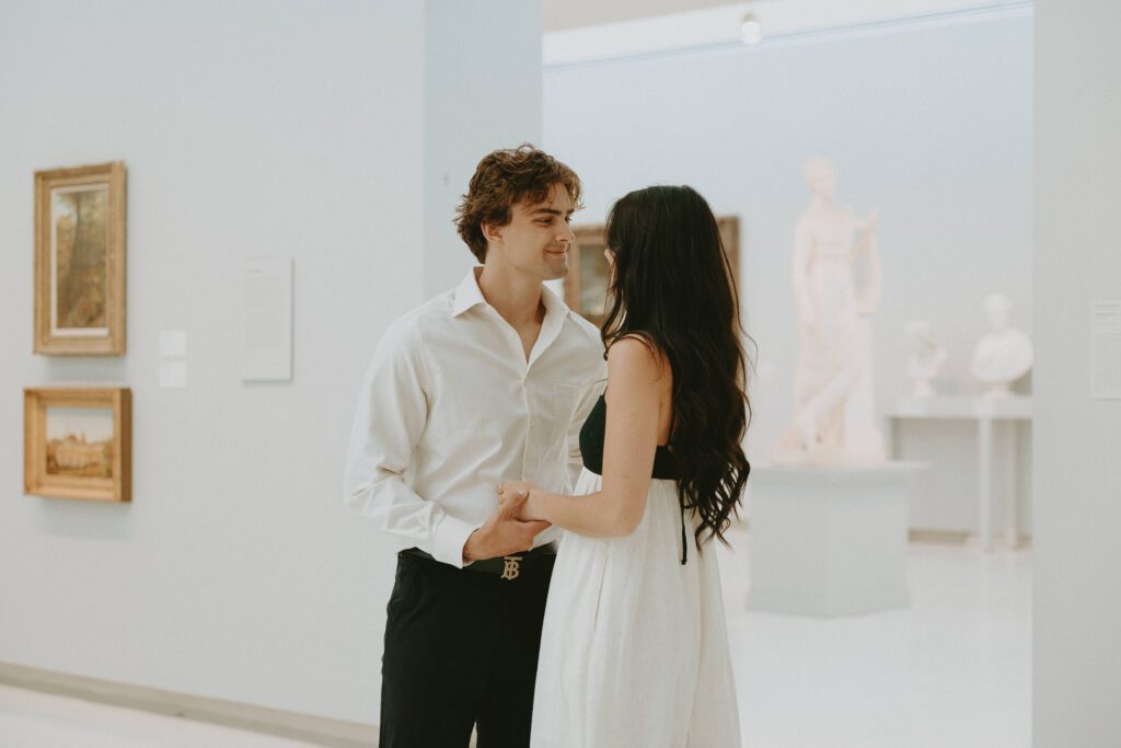 couple holding each other in art gallery taken by pittsburgh wedding photographer