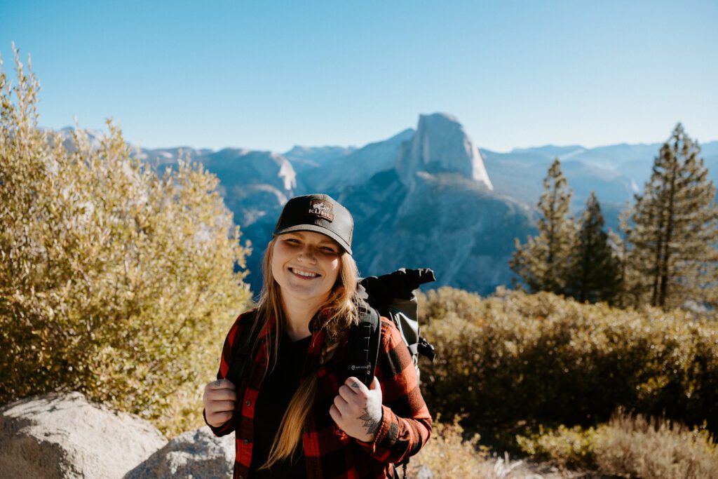 yosemite elopement photographer standing in front of half dome at glacier point