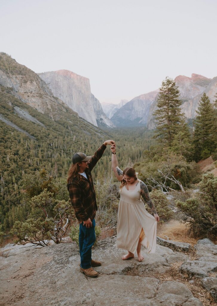 couple dancing at tunnel view during sunset taken by yosemite elopement photographer