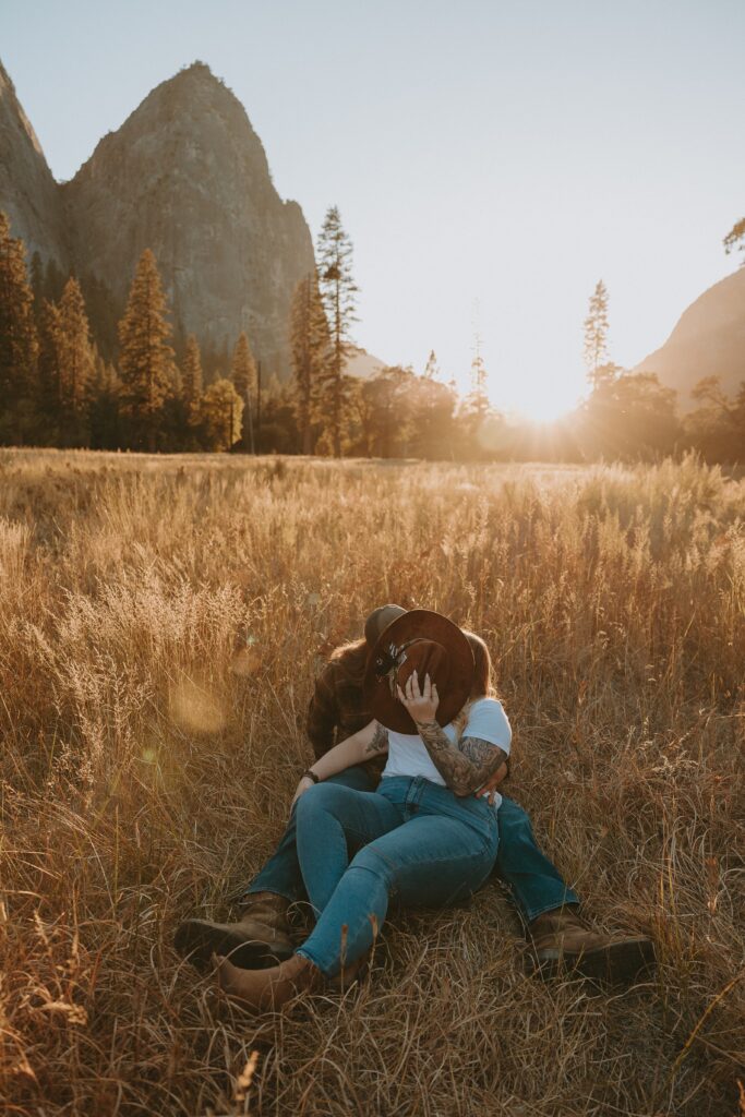 couple with cowboy hat in yosemite valley during sunset taken by yosemite wedding photographer