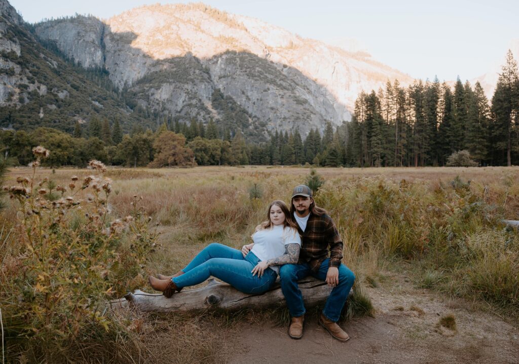 couple holding each other on log taken by yosemite elopement photographer