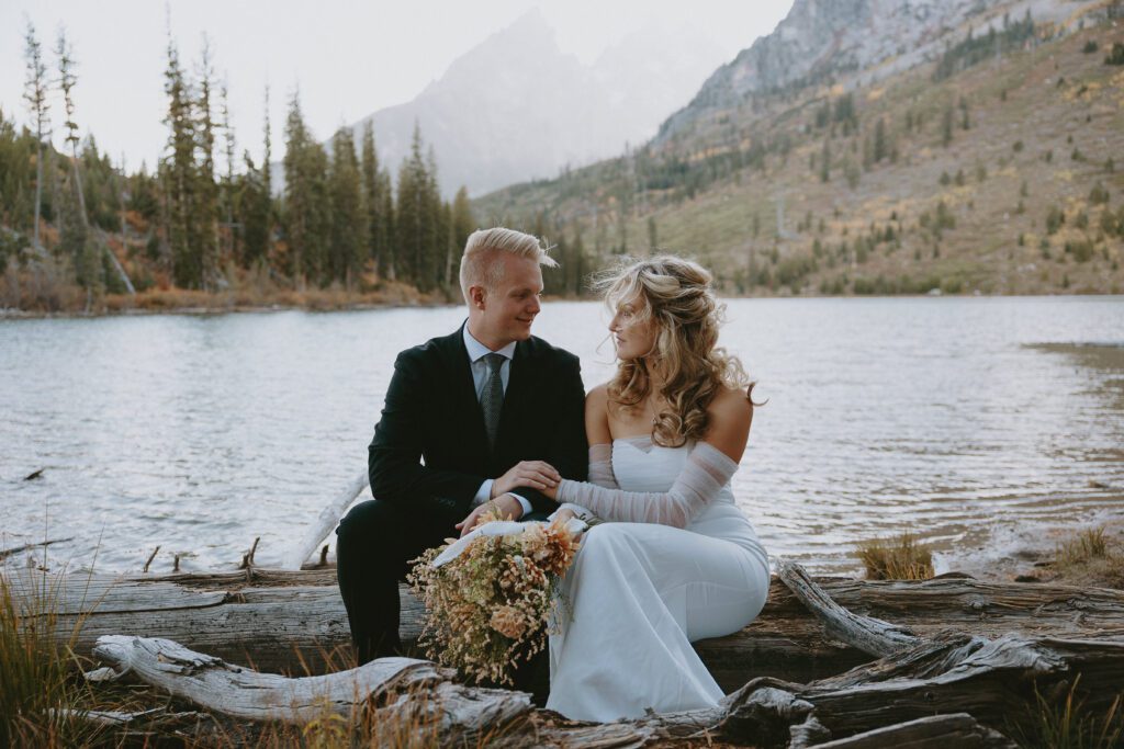 Grand Teton National Park elopement of a couple holding a bouquet and hands.