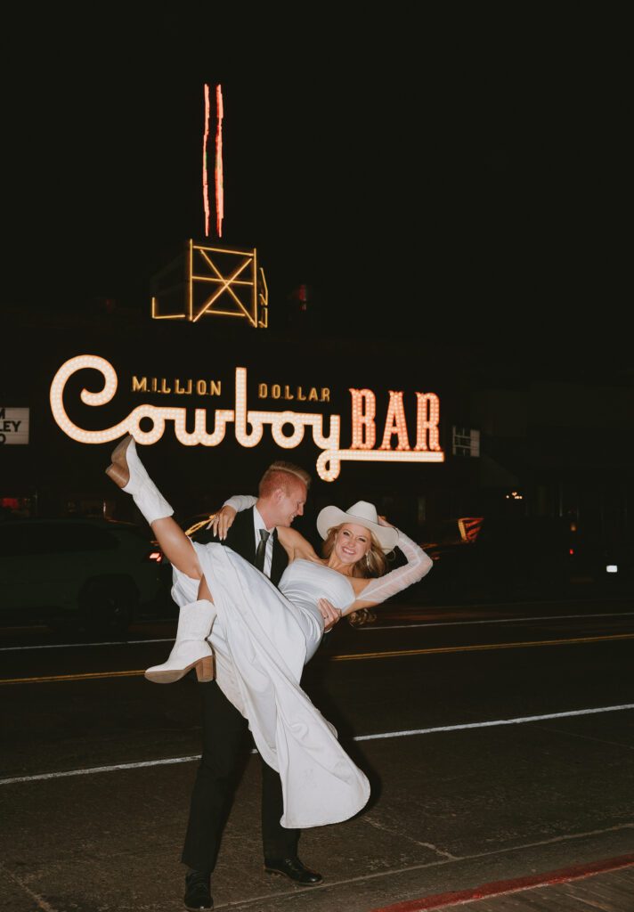 flash photo in front of the million dollar cowboy bar in jackson of a couple on their elopement day