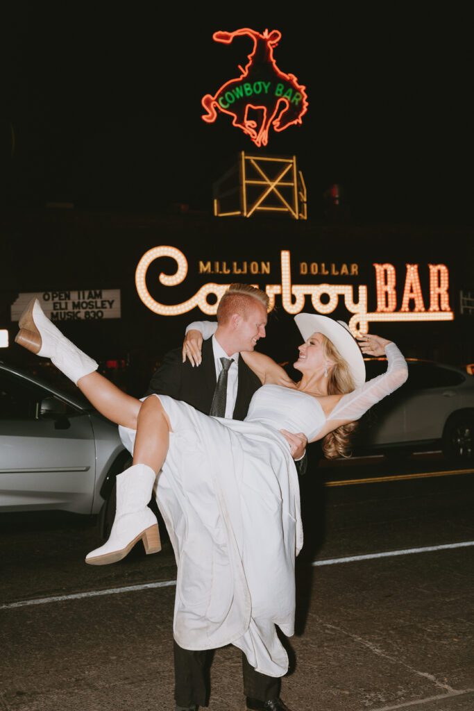 eloping couple in front of the million dollar cowboy bar in the evening