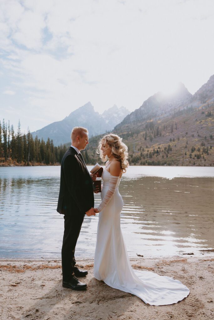 Grand Teton National Park elopement couple exchanging vows and smiling.