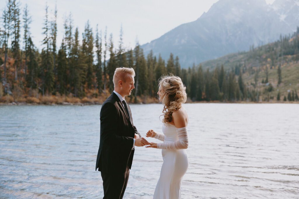 Couple exchanging rings in Grand Teton National Park during their ceremony.