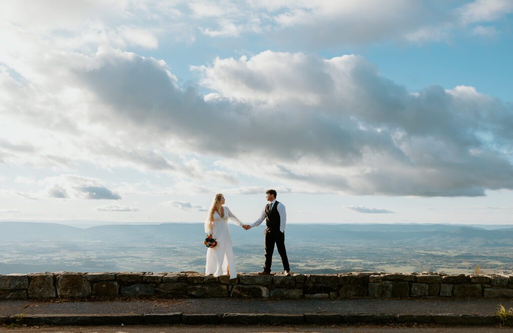 Couple holding hands during fall Shenandoah elopement.