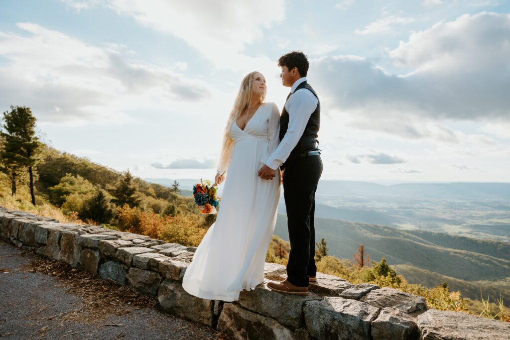 Couple holding hands during fall Shenandoah elopement.