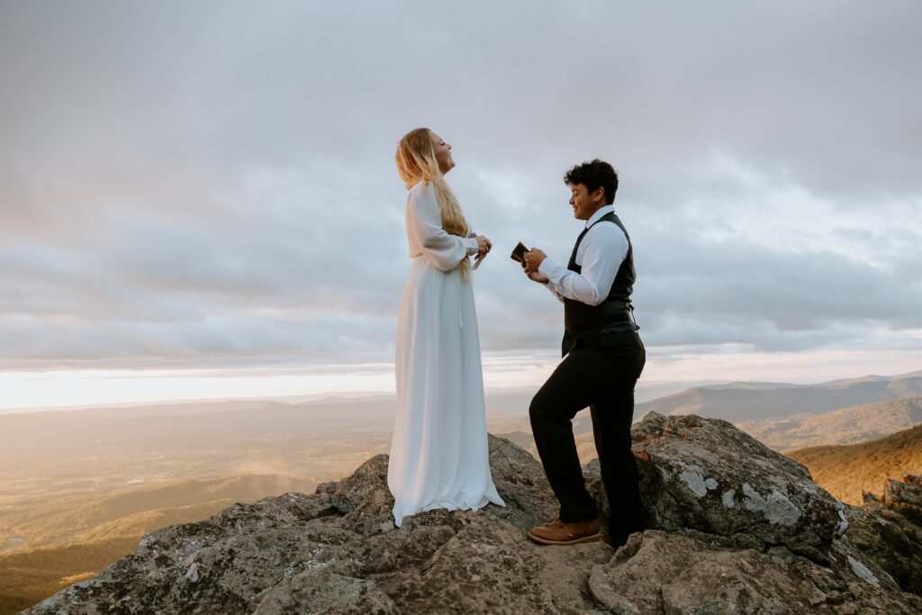 Couple exchanging vows and laughing during a hiking elopement in Shenandoah.