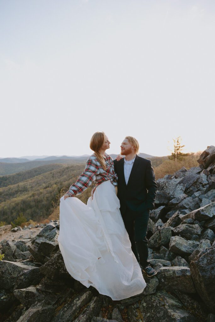 bride holding groom during sunrise elopement in shenandoah