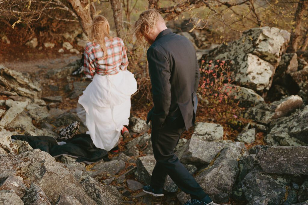 bride and groom walking down trail on their adventure elopement in virginia