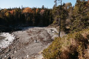 bride and groom walking on little hunters beach in acadia