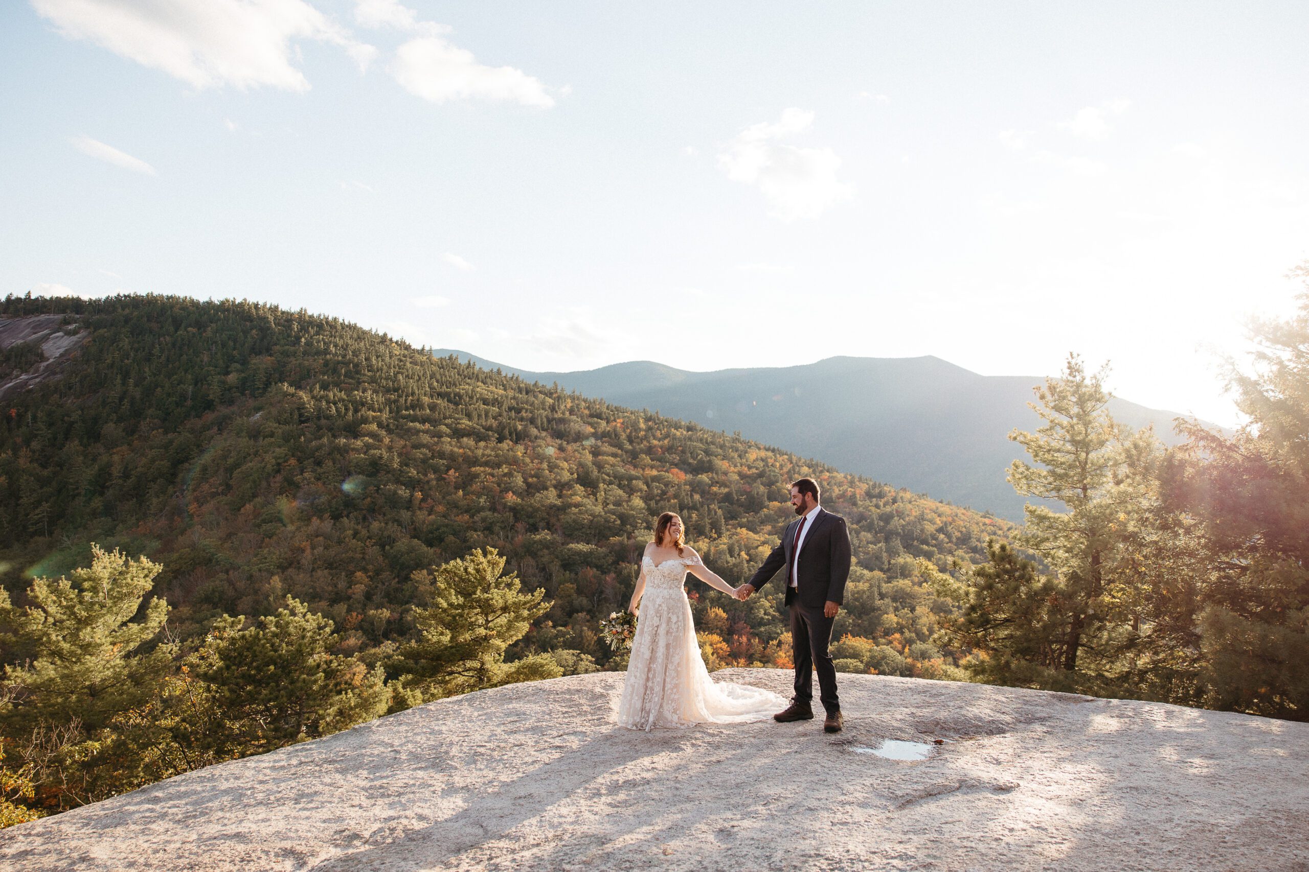 Couple holding hands after their wedding ceremony at Cathedral Ledge State Park in New Hampshire